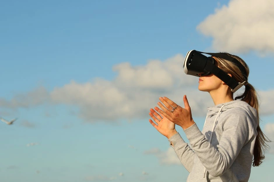 a woman wearing a VR headseat outdoors