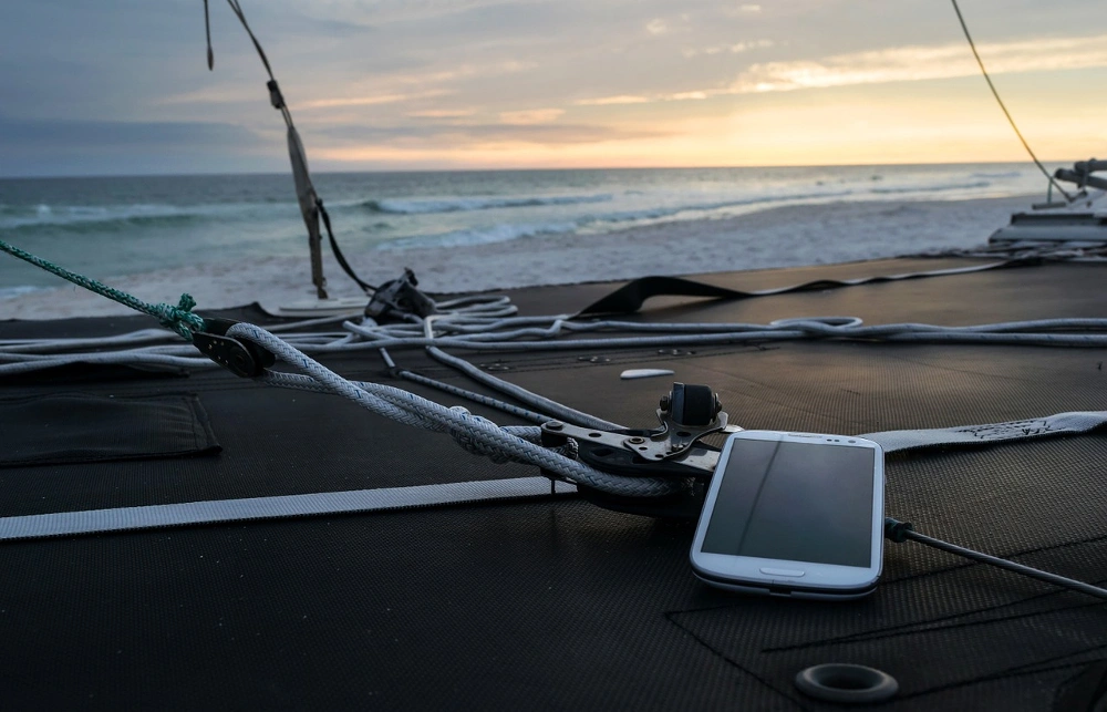a smartphone lying on the deck of a ship
