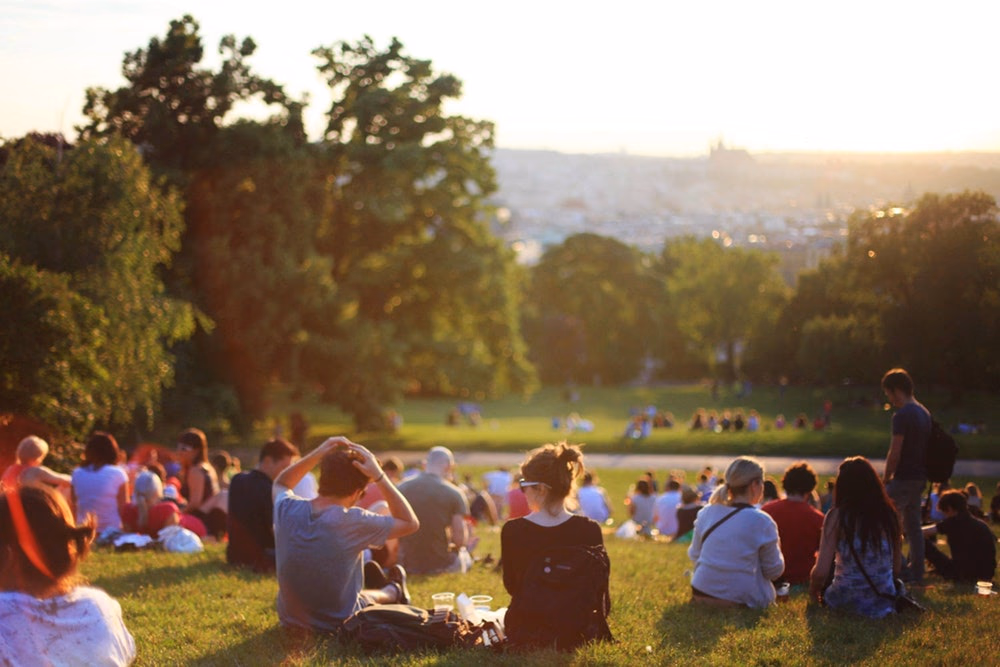 young people sitting in a park